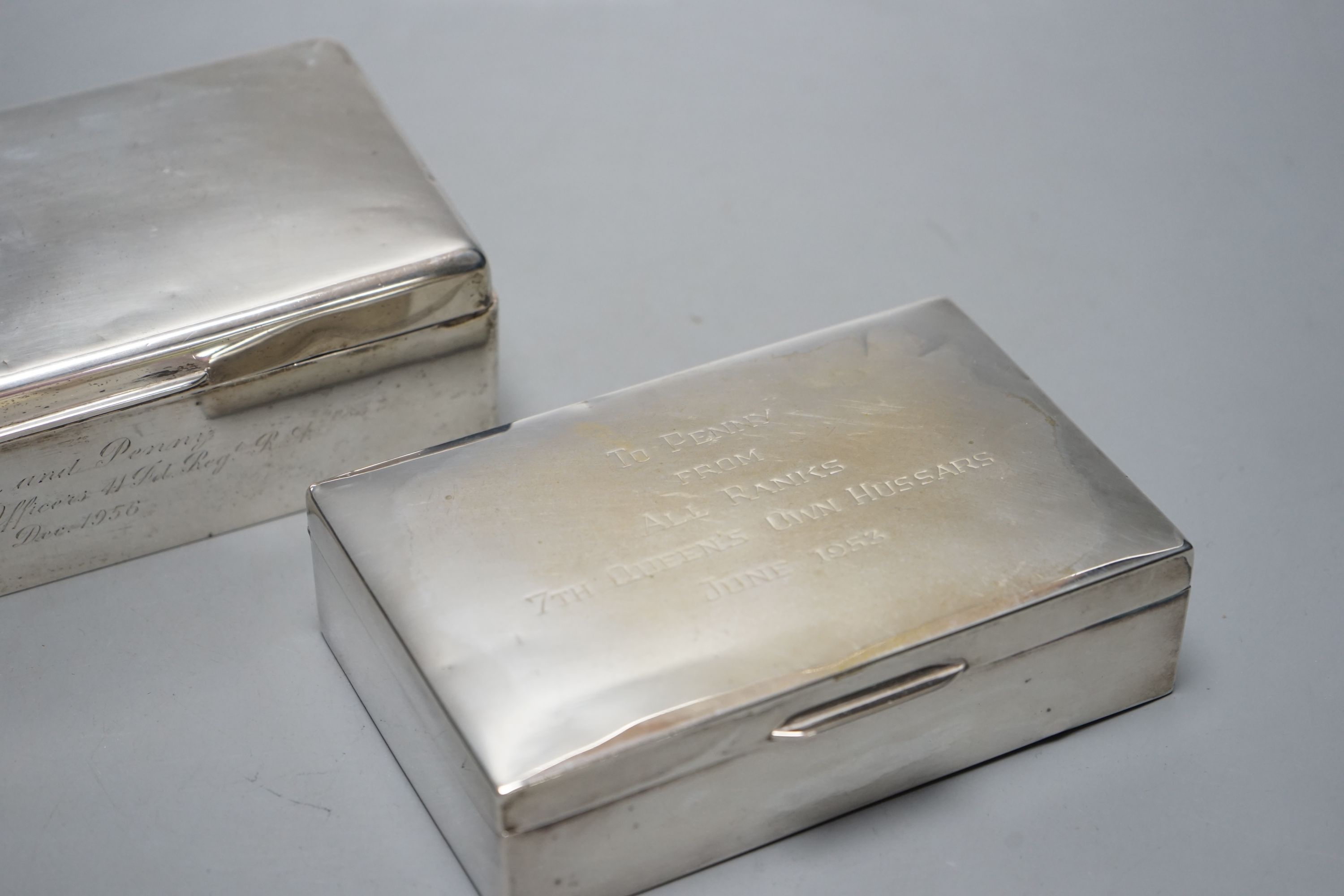 A 1950's silver mounted silver cigarette box, 18.2cm and a silver plated cigarette box.